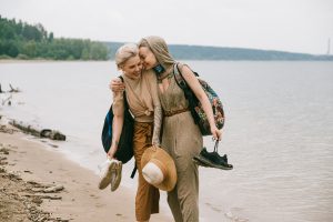 two women hugging on a beach